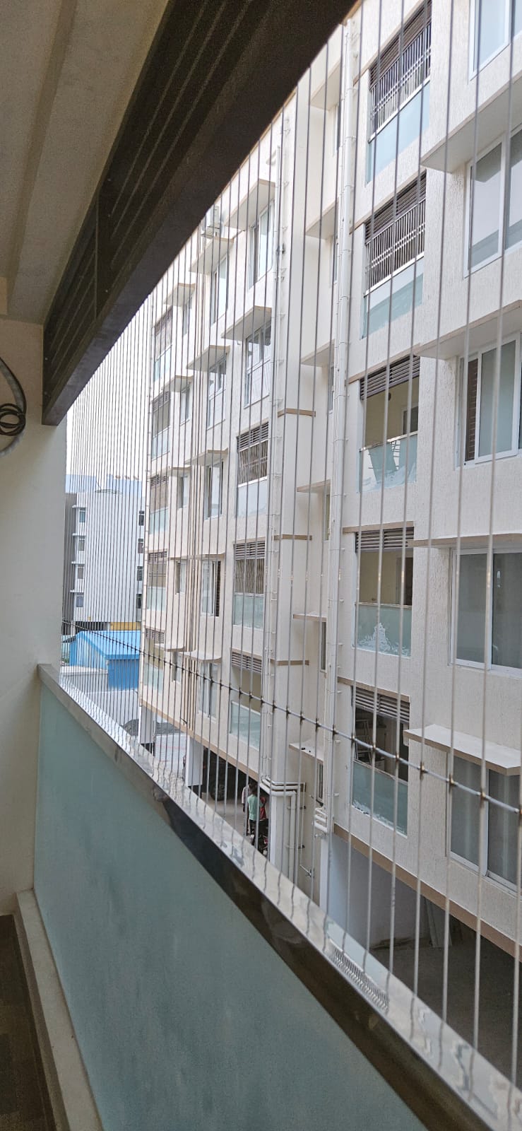 Close detail of stainless steel invisible grill cables being tensioned during installation