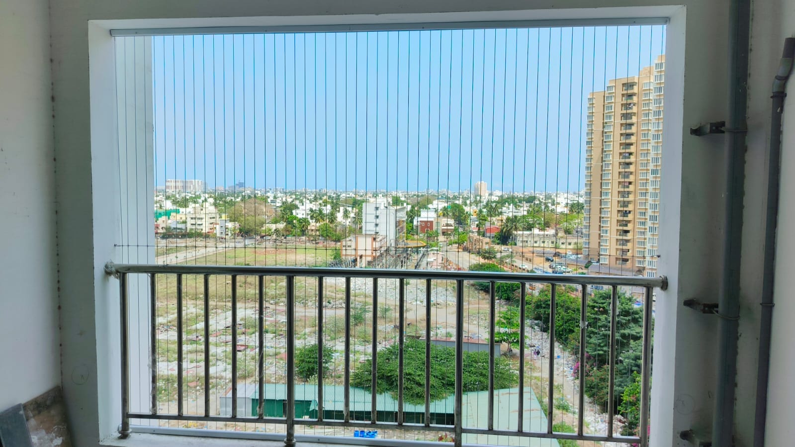 Invisible grills installed on a Chennai apartment balcony with an open view