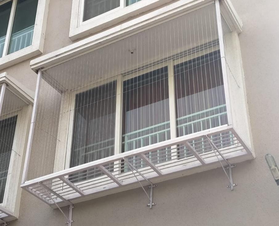 Window invisible grills fitted to a kitchen window in a Chennai apartment